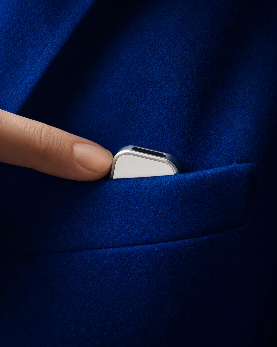 Presence Key set into the lapel of a cobalt blue jacket