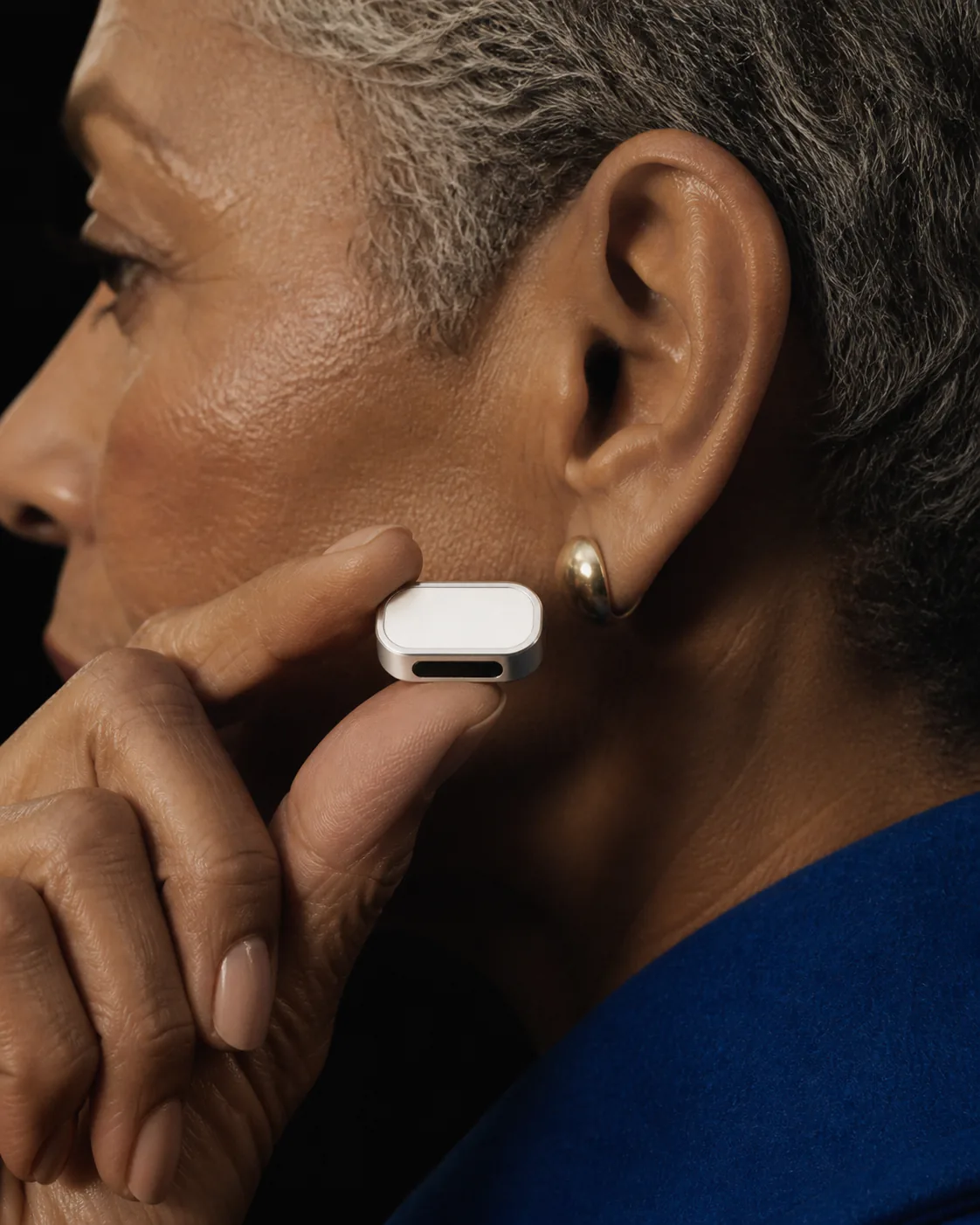 Presence Key worn beside the ear in a close profile portrait